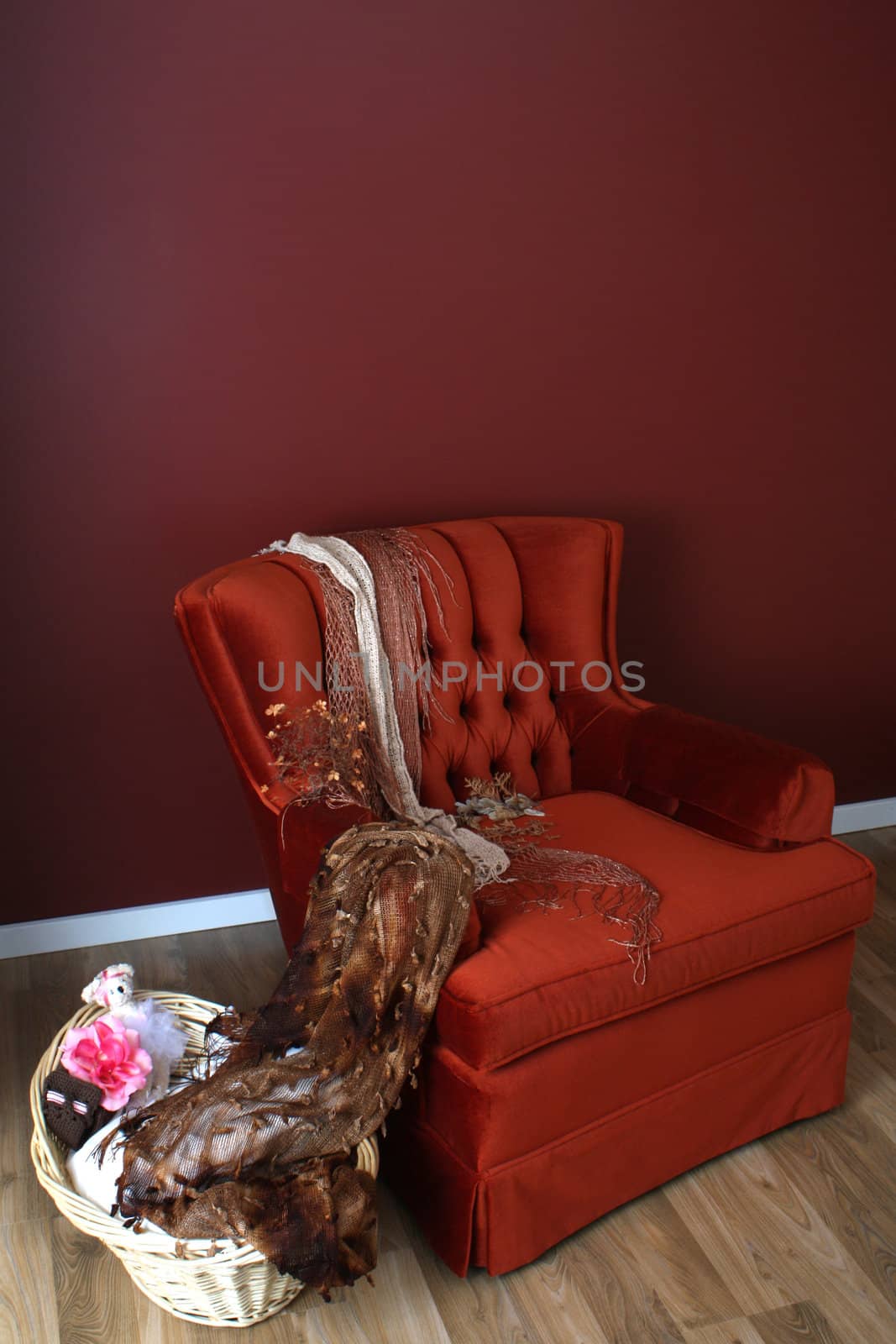Red chair with basket on wooden floor