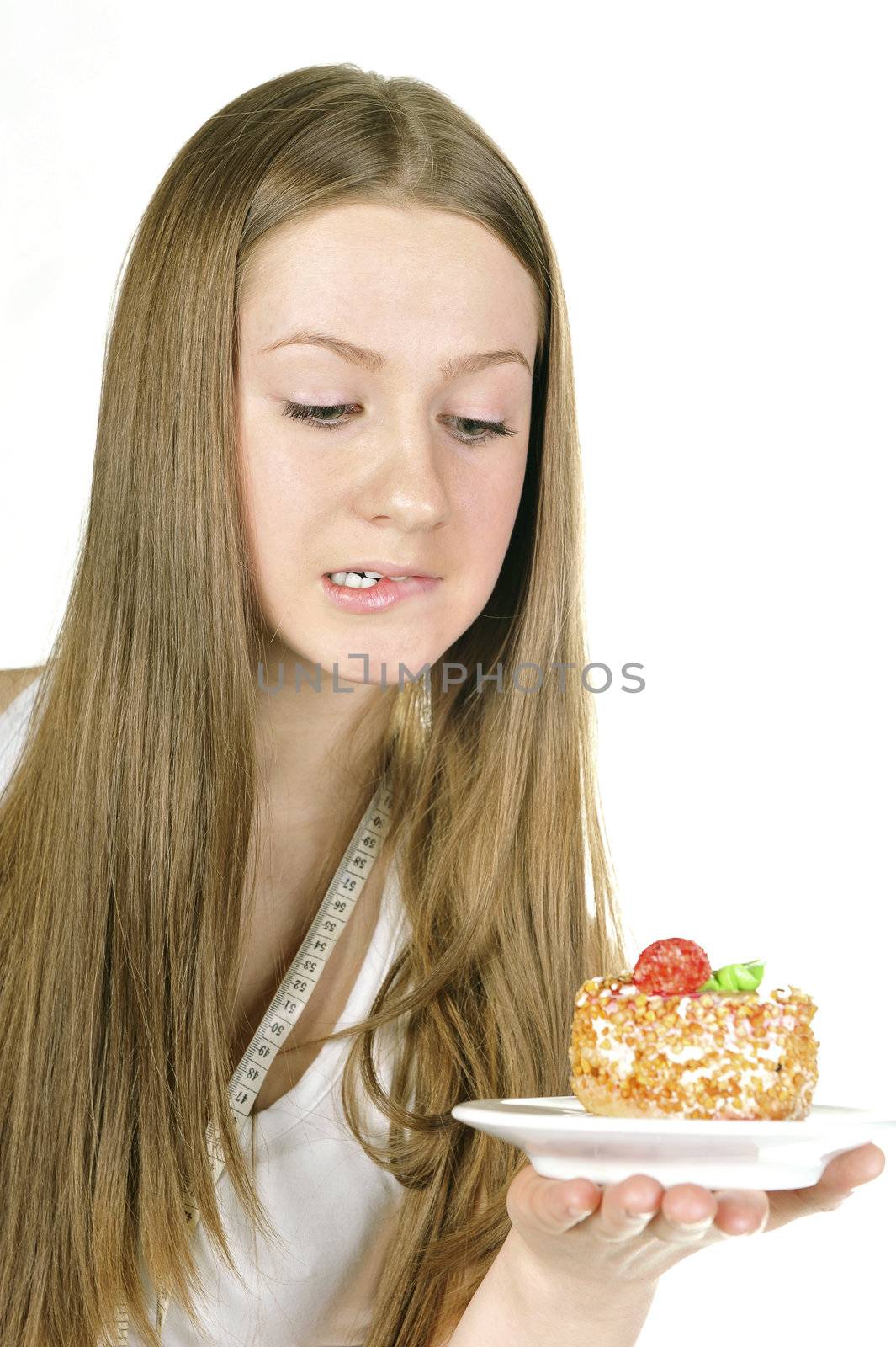  young cute girl on diet look with pleasure at cake 