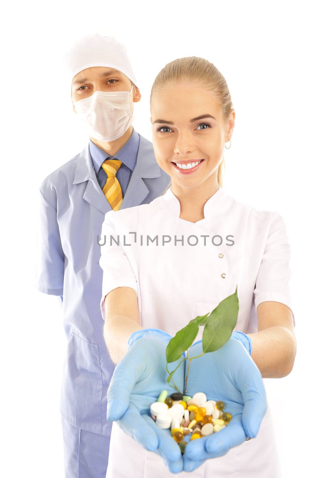  young doctor and nurse  holding pills and a plant 