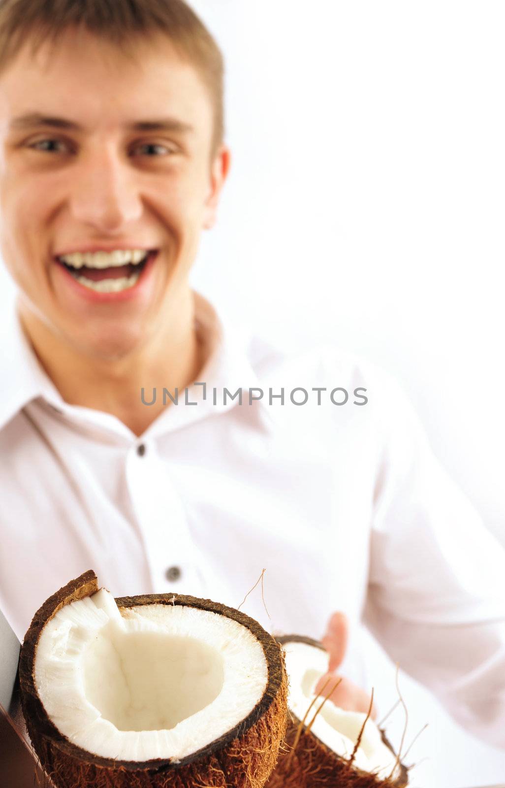 Young cheerful man with coconut isolated on white