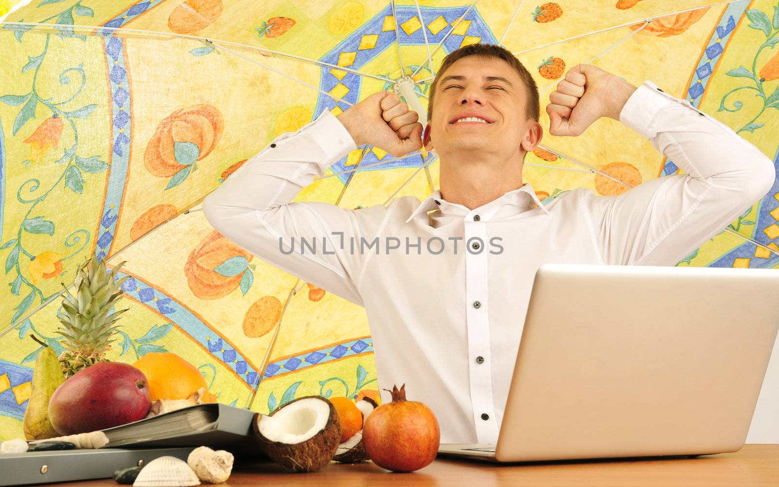 young businessman having dreams about vacations