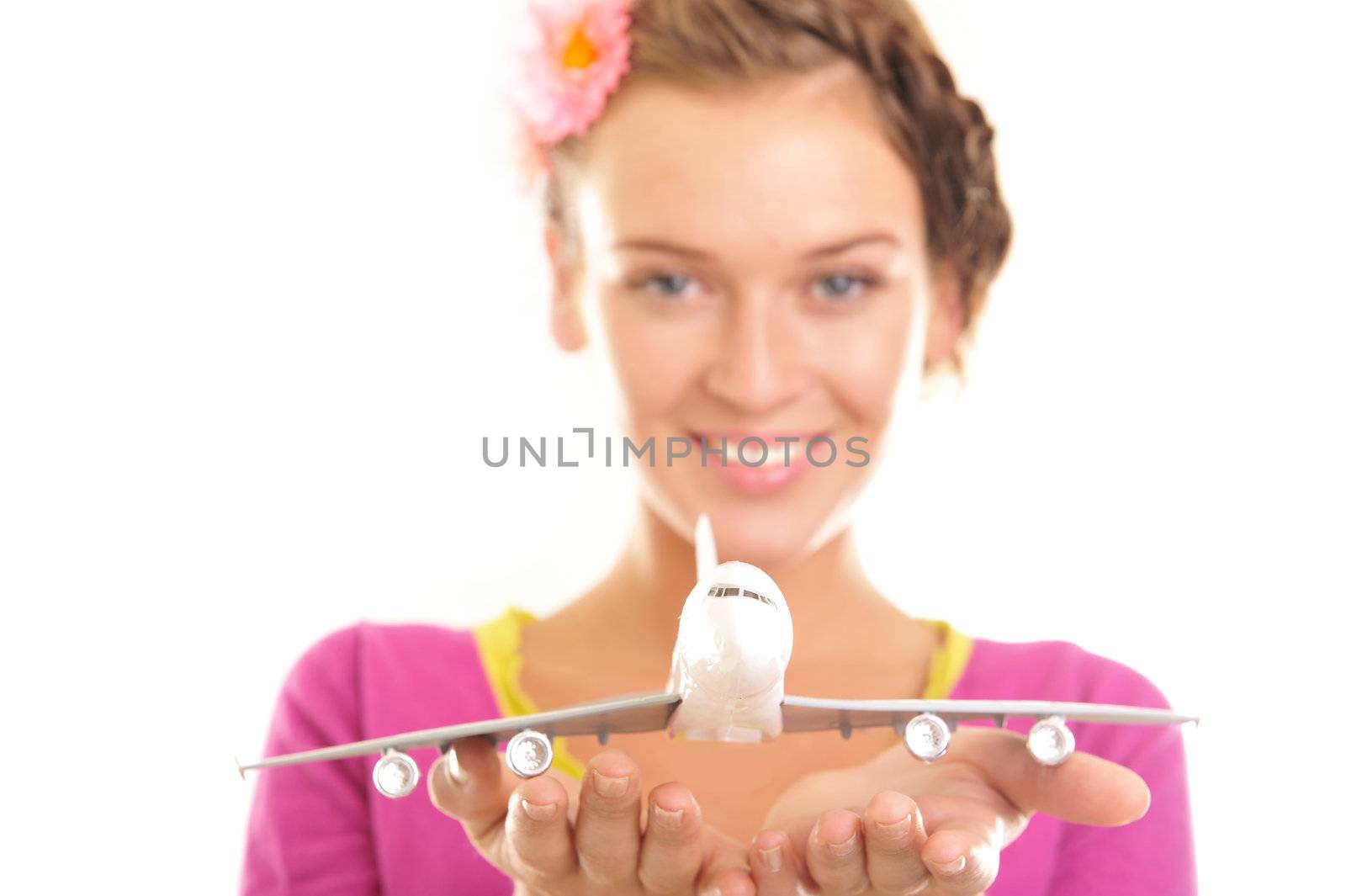 young woman holding a plane isolated on white