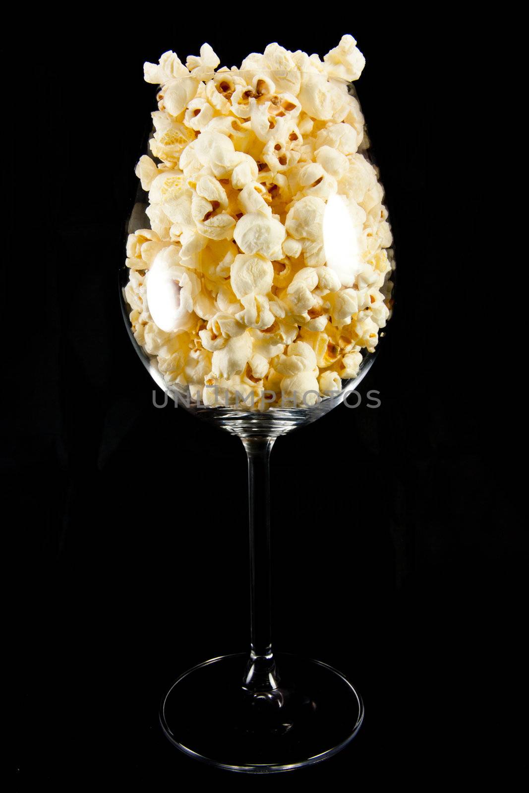 Picture of a wine glass with popcorn