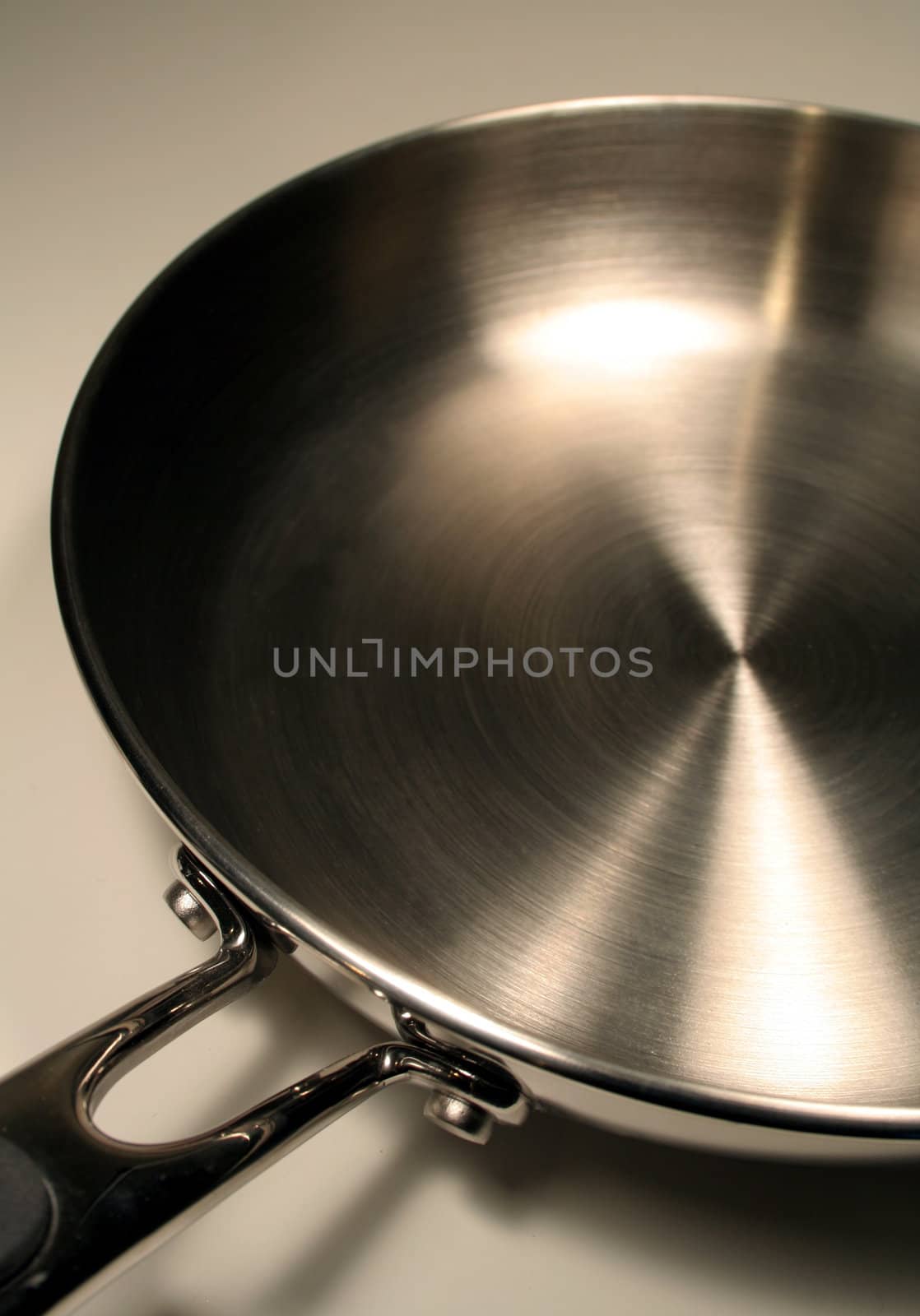 A close up of a stainless steel frying pan.