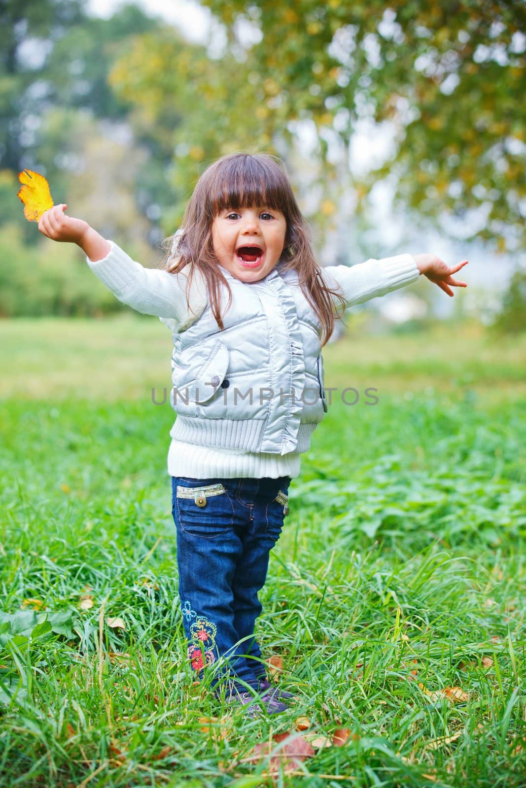 Pretty little girl in silver walking in the park