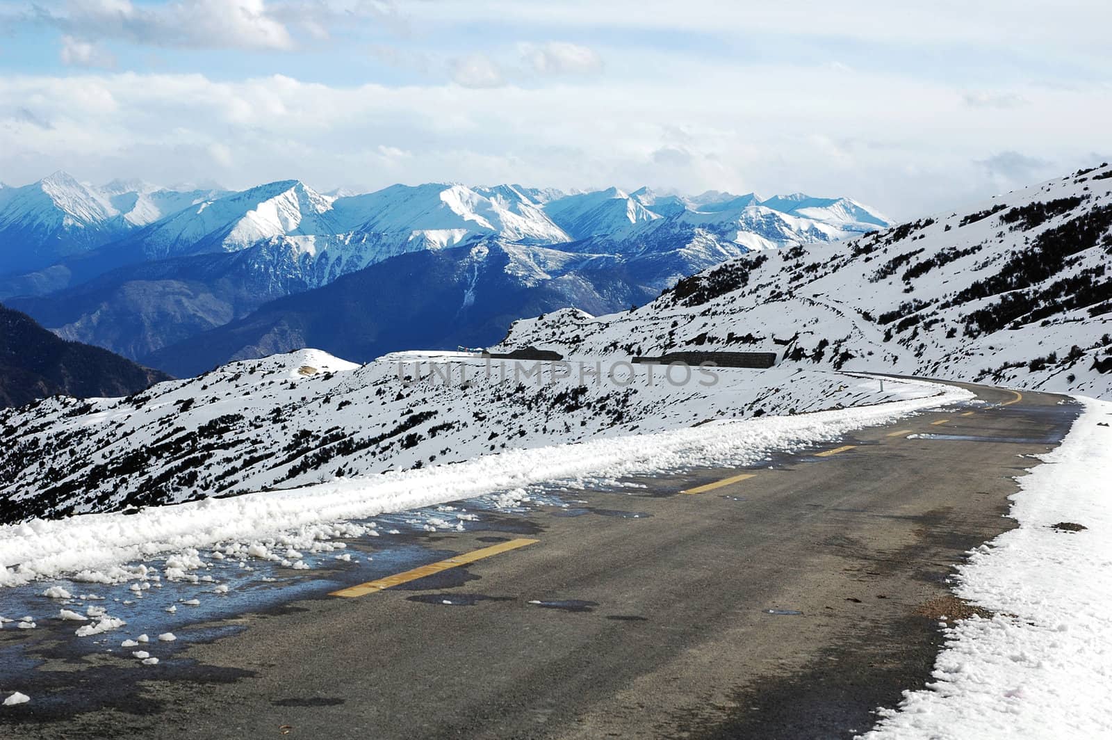 Landscape of snow-capped mountains and cloudy skies in winter