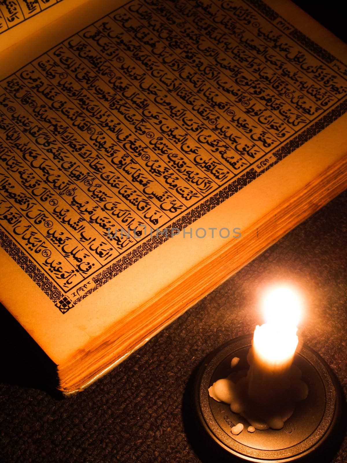 Al Qur'an and candle light.