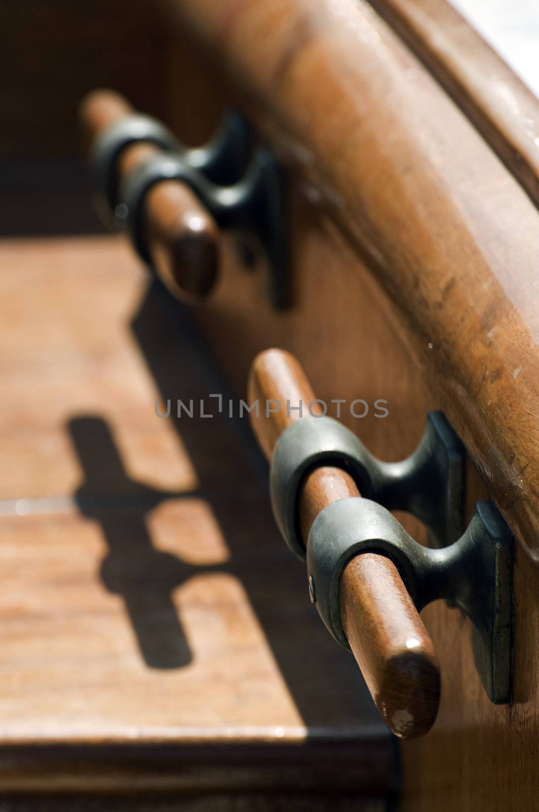 Wooden bitts with shadow on a sailboat