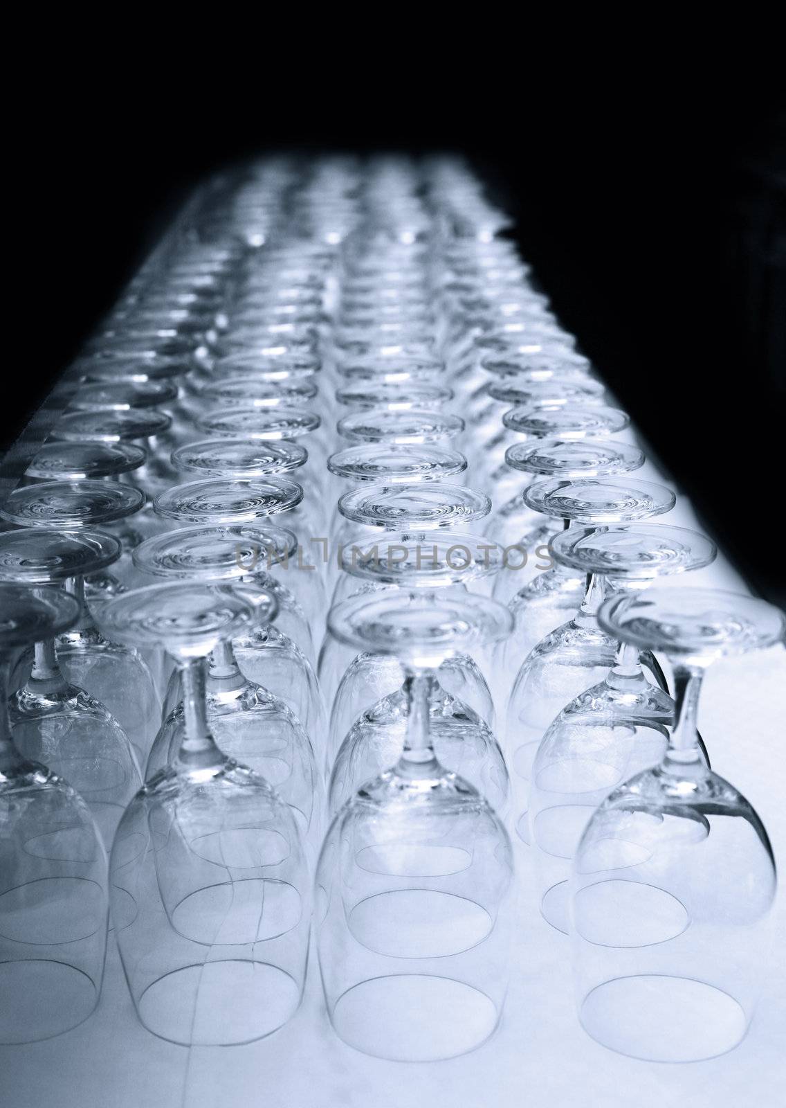Photo of many upside-down lined up glasses