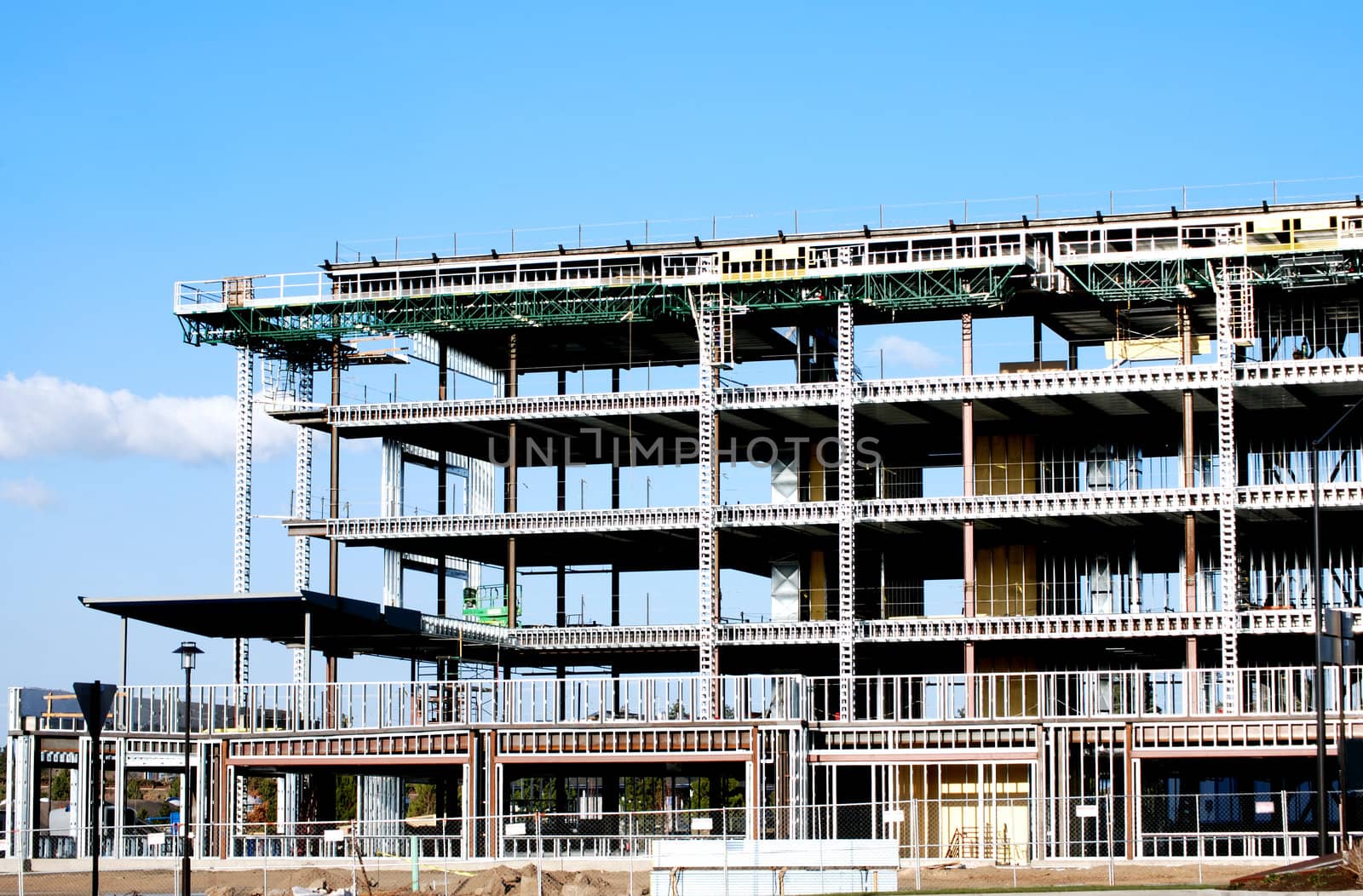 Horizontal image of a steel framed building under construction.