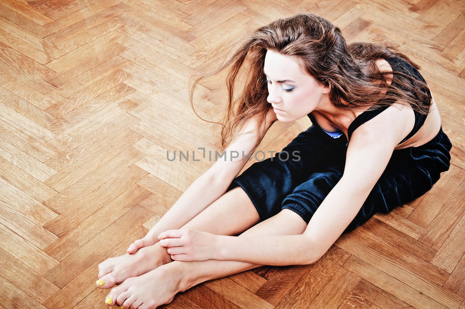 Young woman to training of fitness exercise on the parquet floor