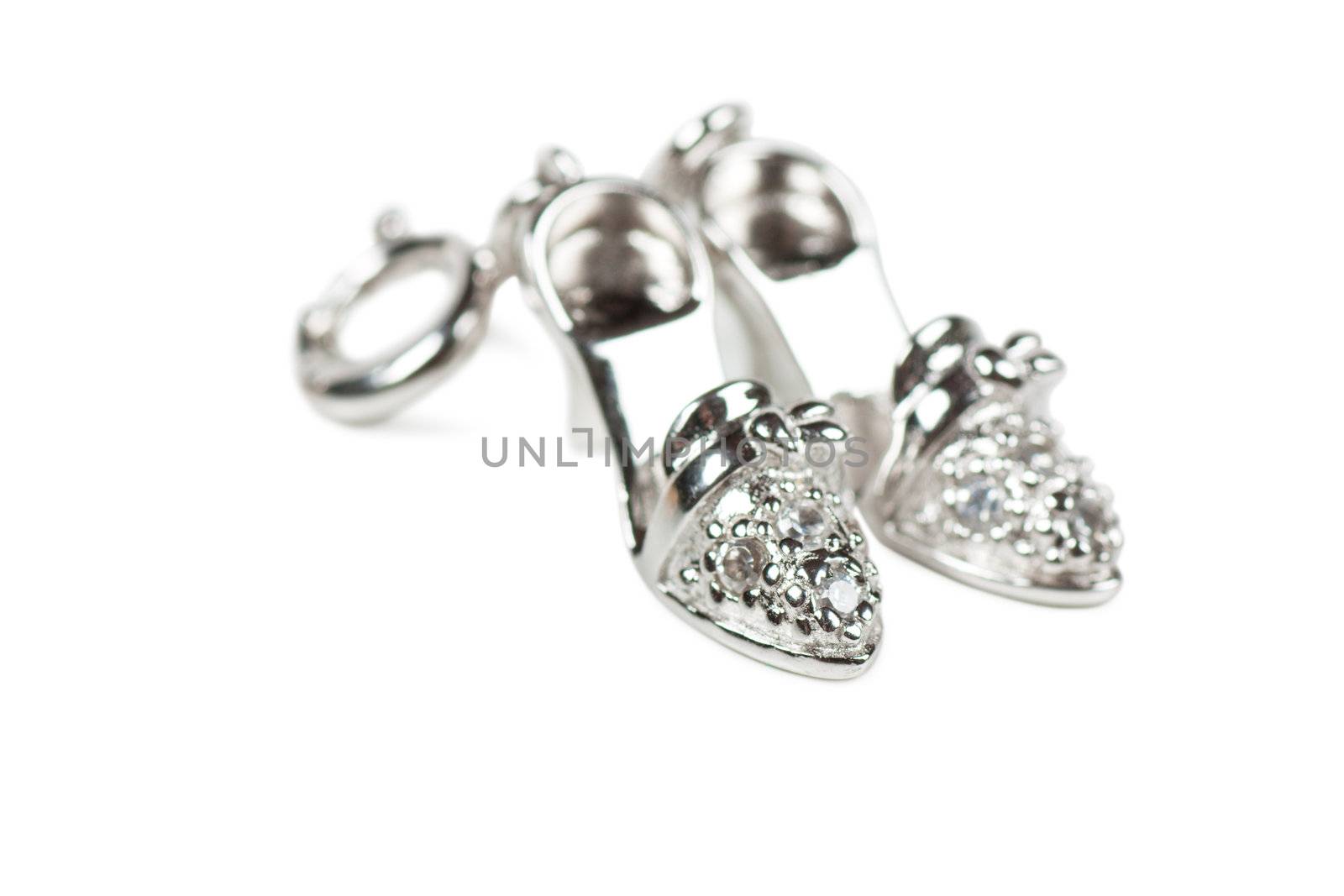 Macro view of little silver pendants in form of shoes