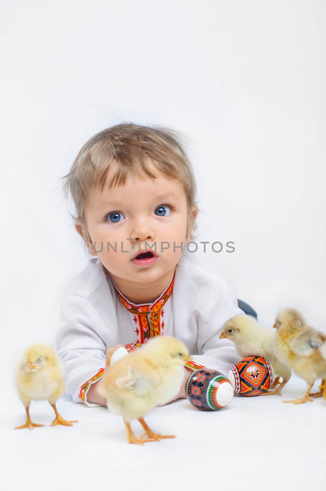 Cute little boy in embroidered with Easter eggs and easter chicks