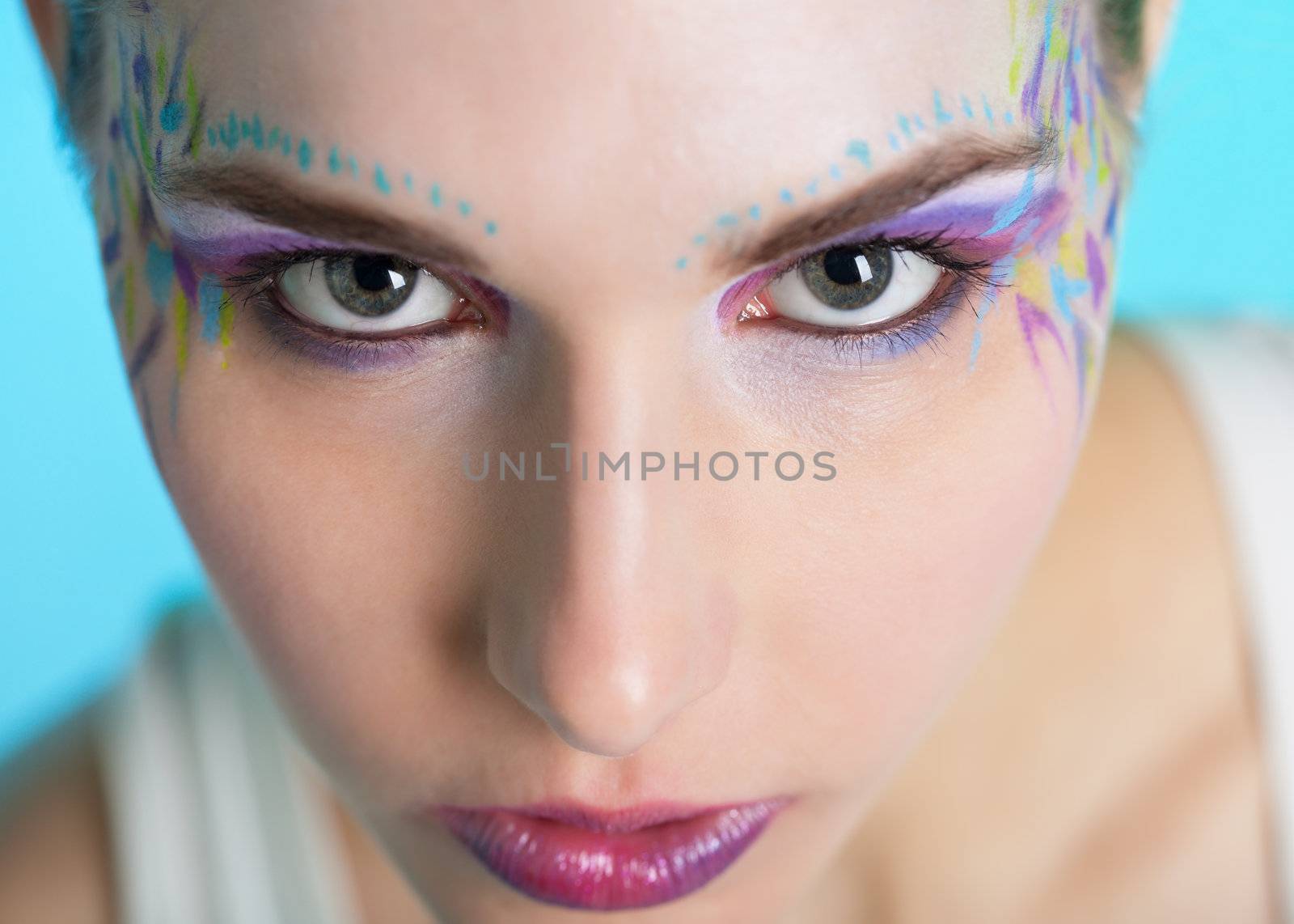 Closeup portrait of a pretty young woman with face art