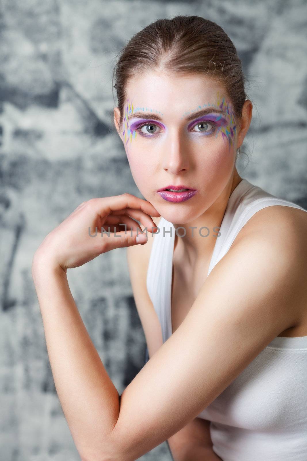 portrait of a pretty young woman with face art