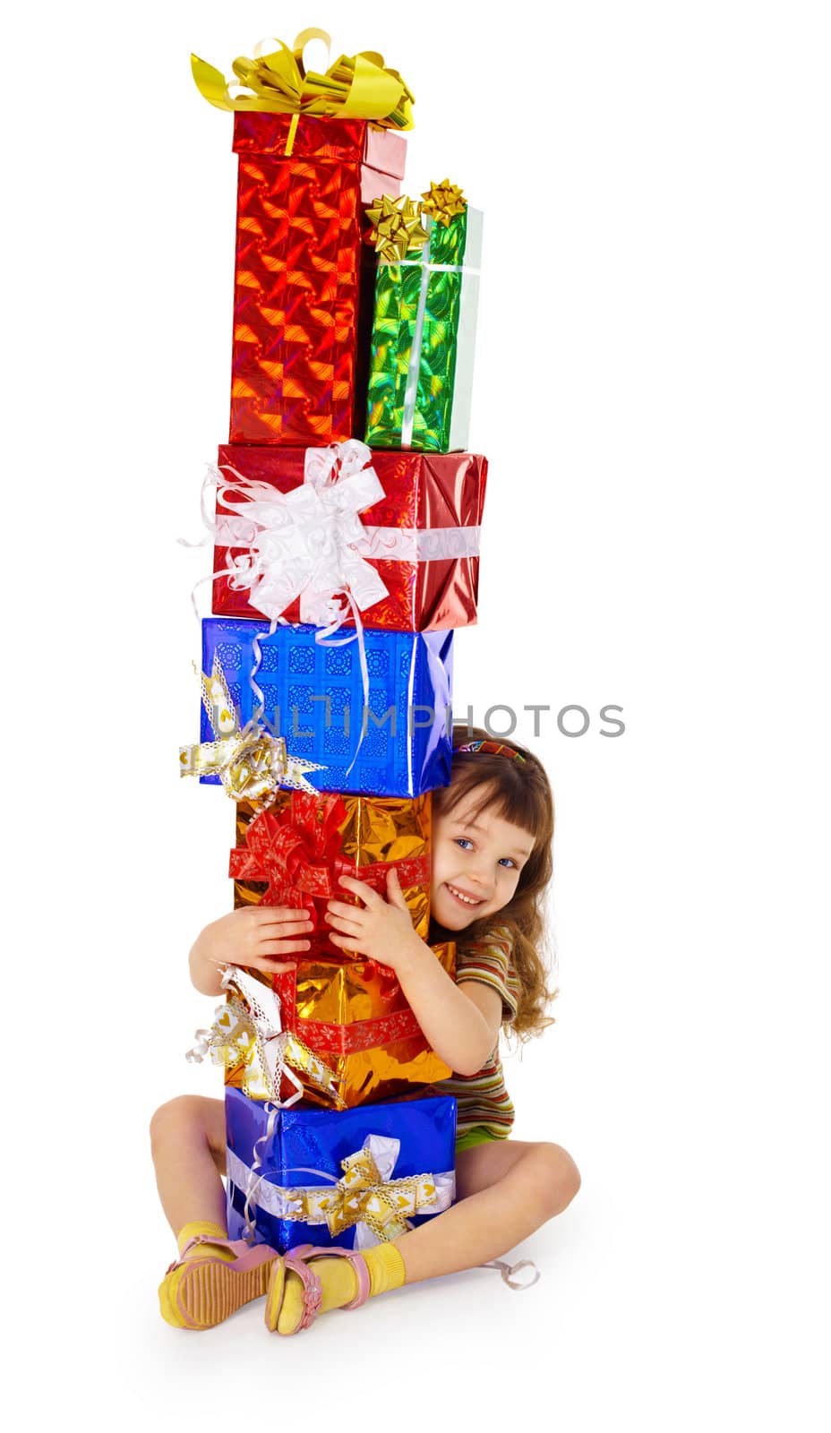 A little girl hugs birthday gifts, isolated on a white background