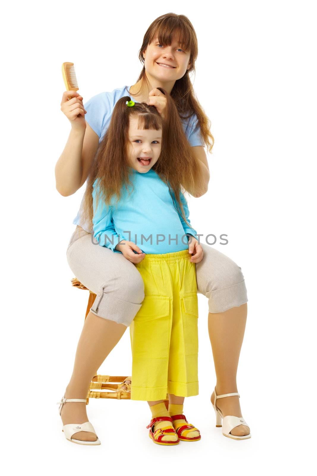 Cheerful mum and daughter do a hairdress on a white background