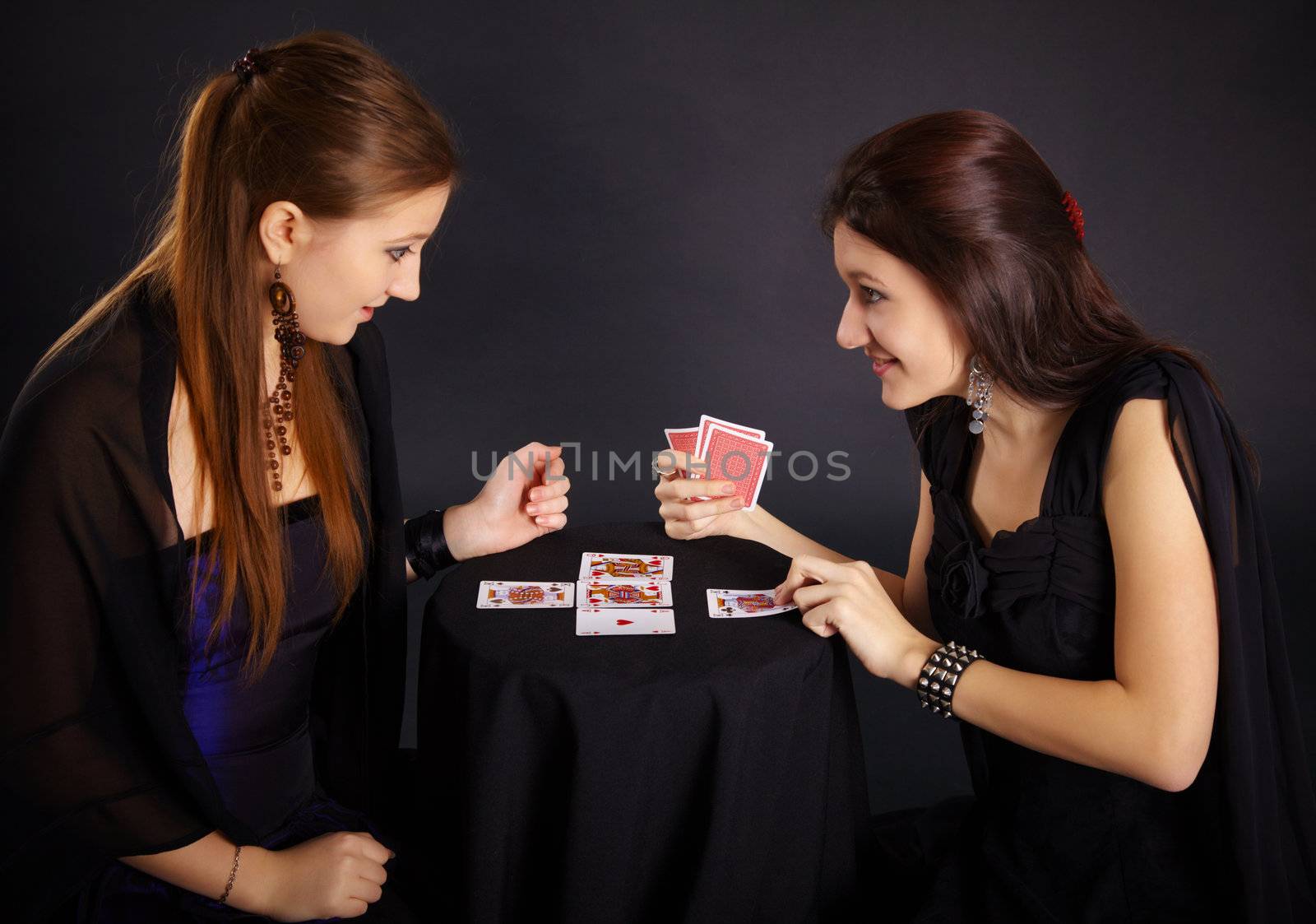 Two girls friends engaged in fortune-telling cards by pzaxe