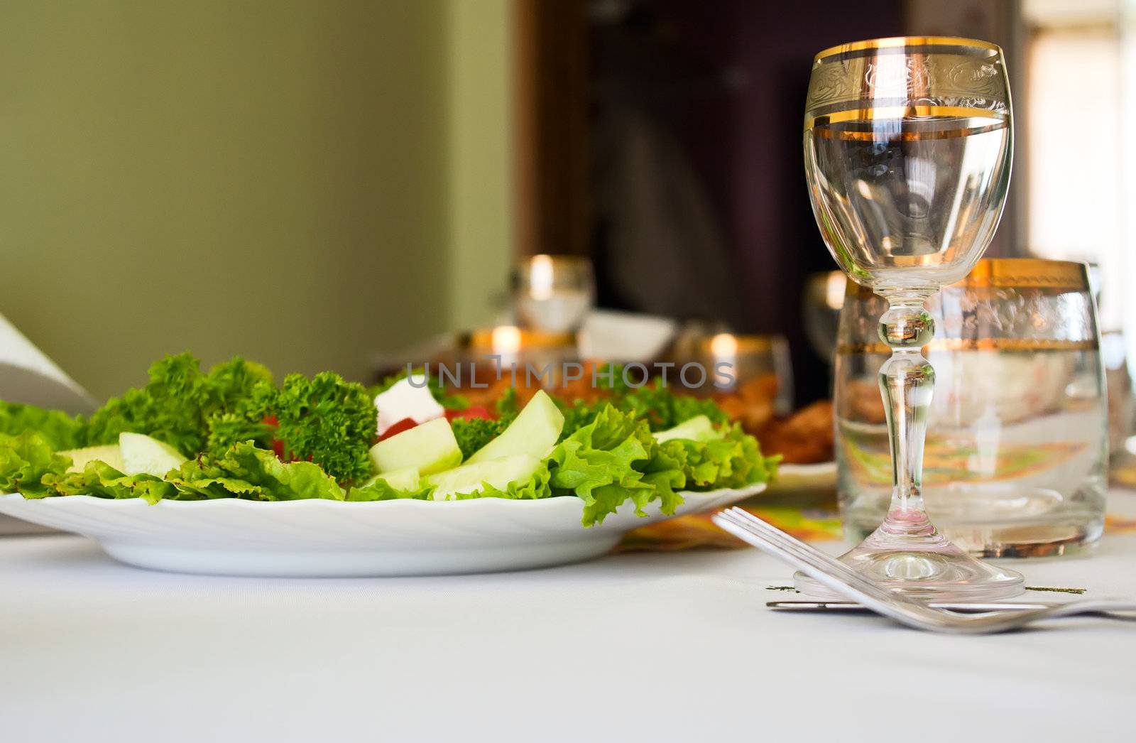 glass and salad and dinner table 
