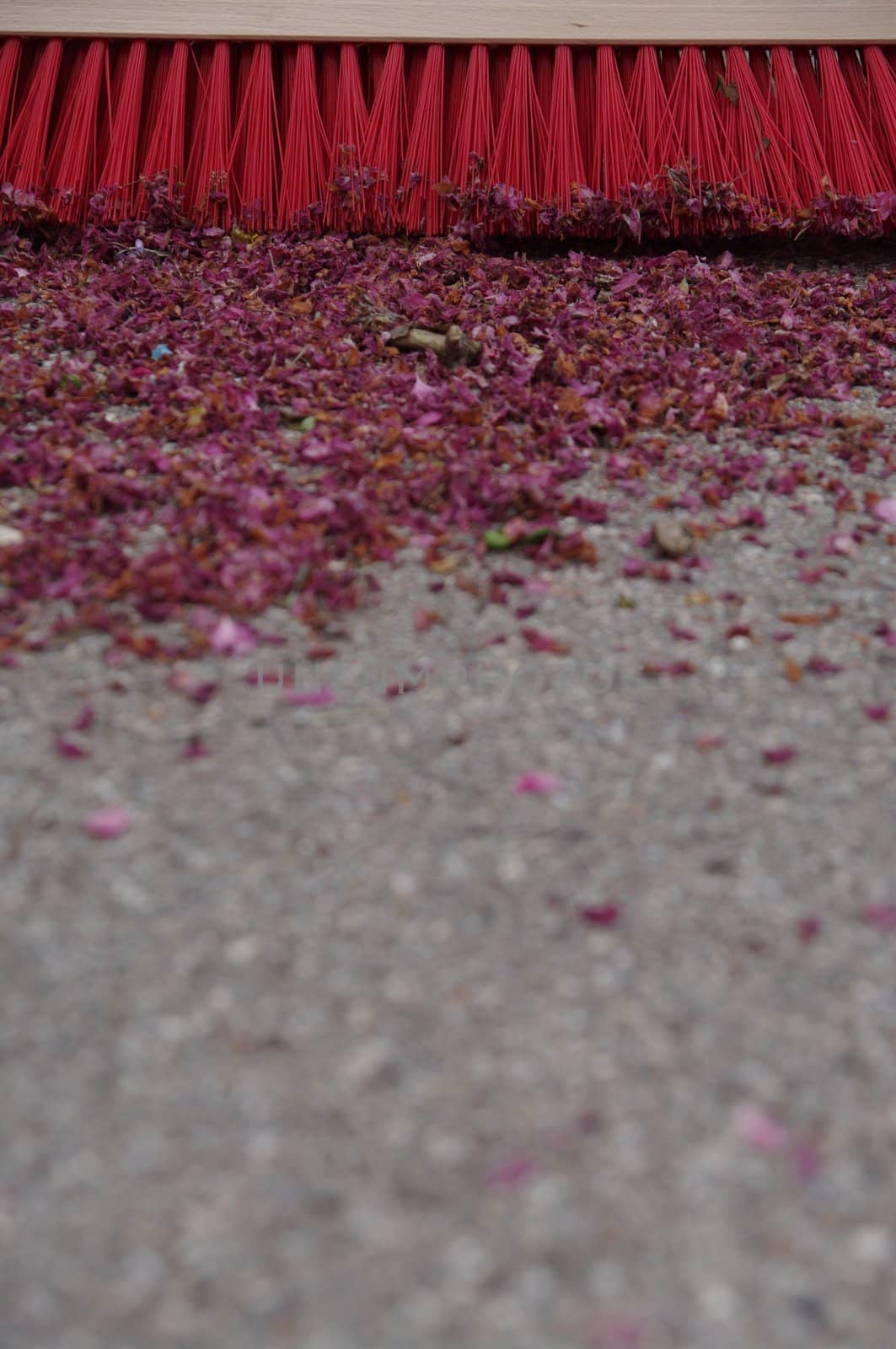 sweeping the sidewalk with a broom