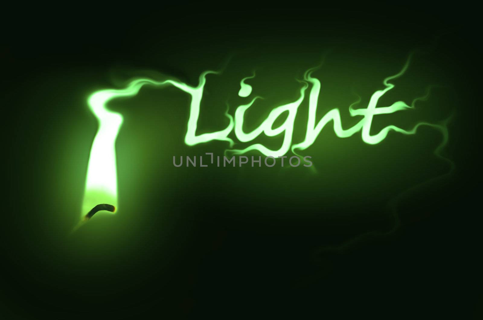 Close up on a single ignited candle wick with green flame morphing into the word 'light' against a black background.