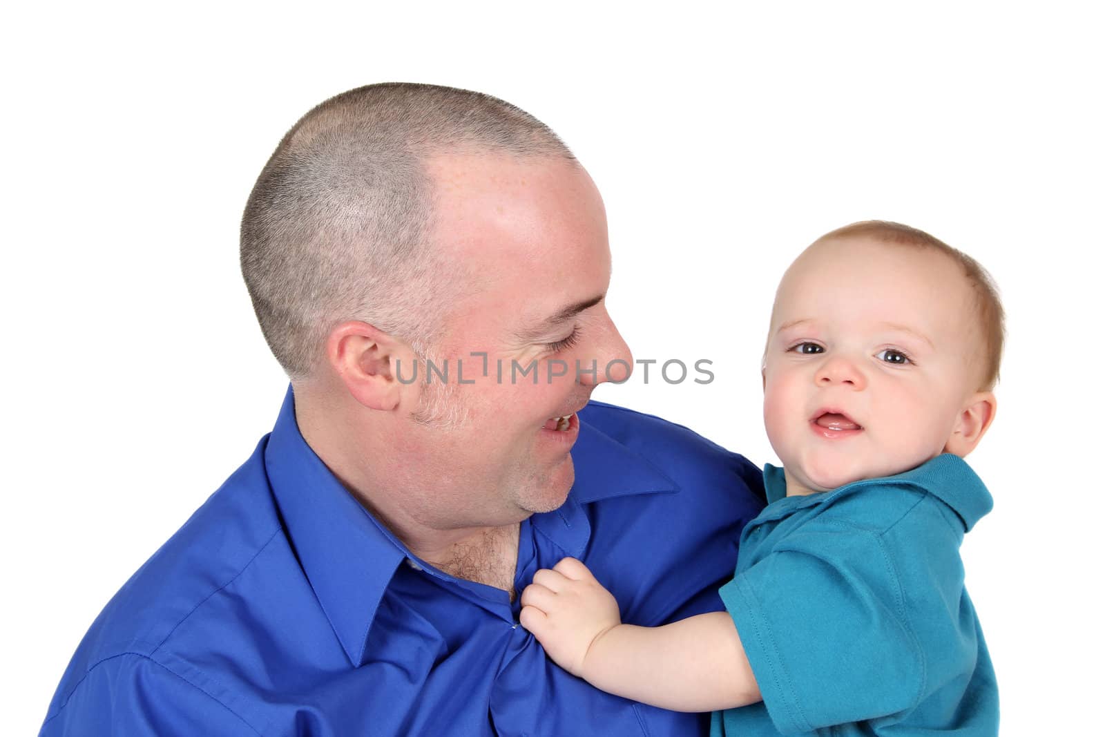 Father and son in blue shirts against white background