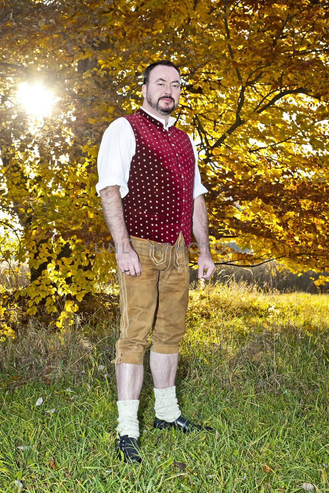 A traditional bavarian man in the autumn nature