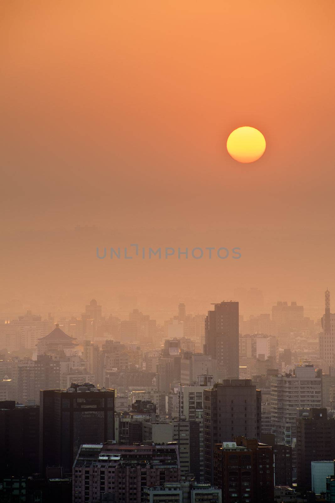 Sunset city scenery with sun and buildings in Taipei, Taiwan, Asia.