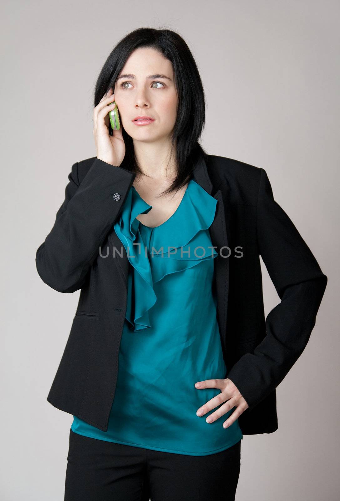 Worried business woman talking on the cell phone by anikasalsera