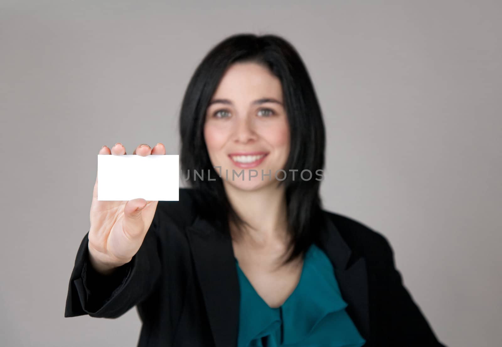 Smiling woman showing a business card with copy space. Focus on the card.