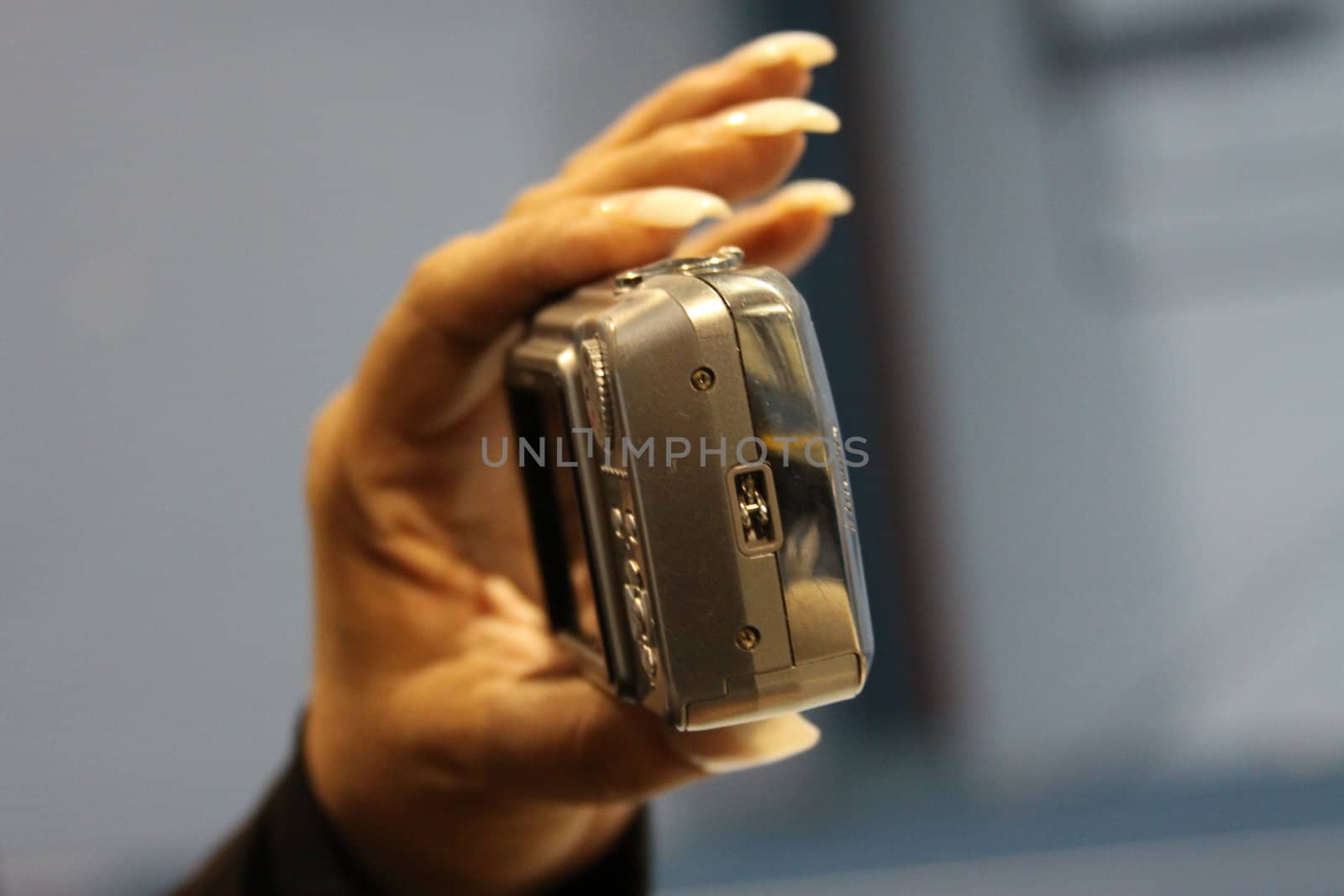 Close up of woman's hand holding digital camera.