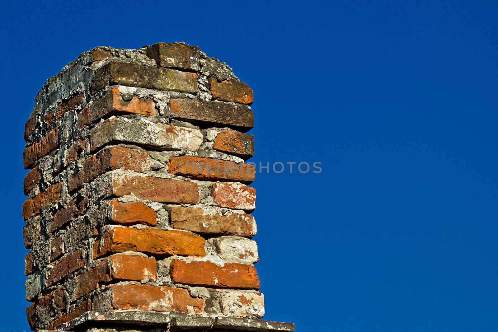 Old brick chimney and blue sky by xbrchx