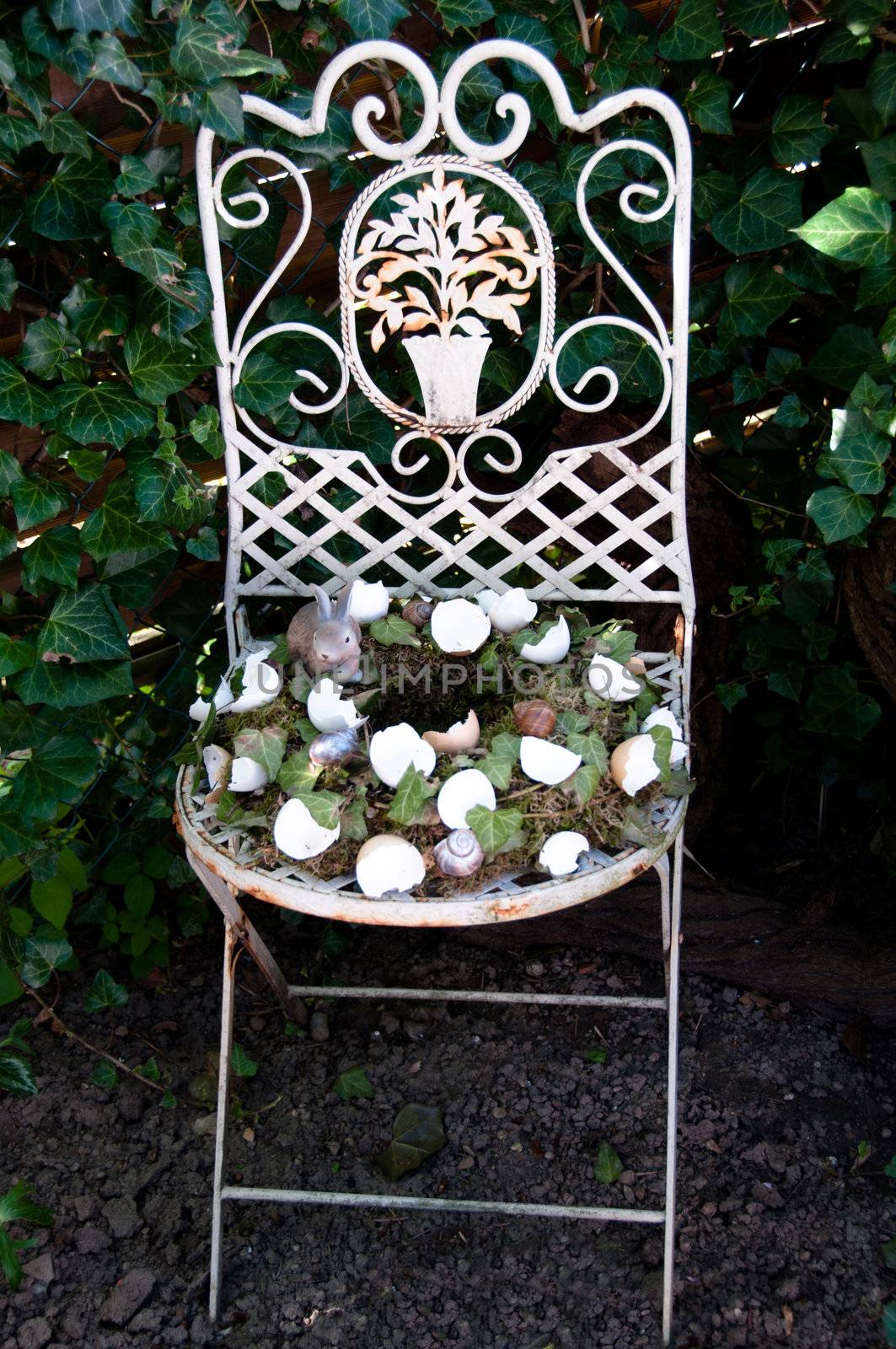 Easter Egg Wreath Decoration On Old Chair in Garden