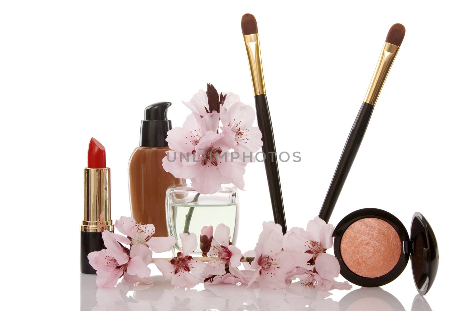 cosmetics and cherry flower on white background