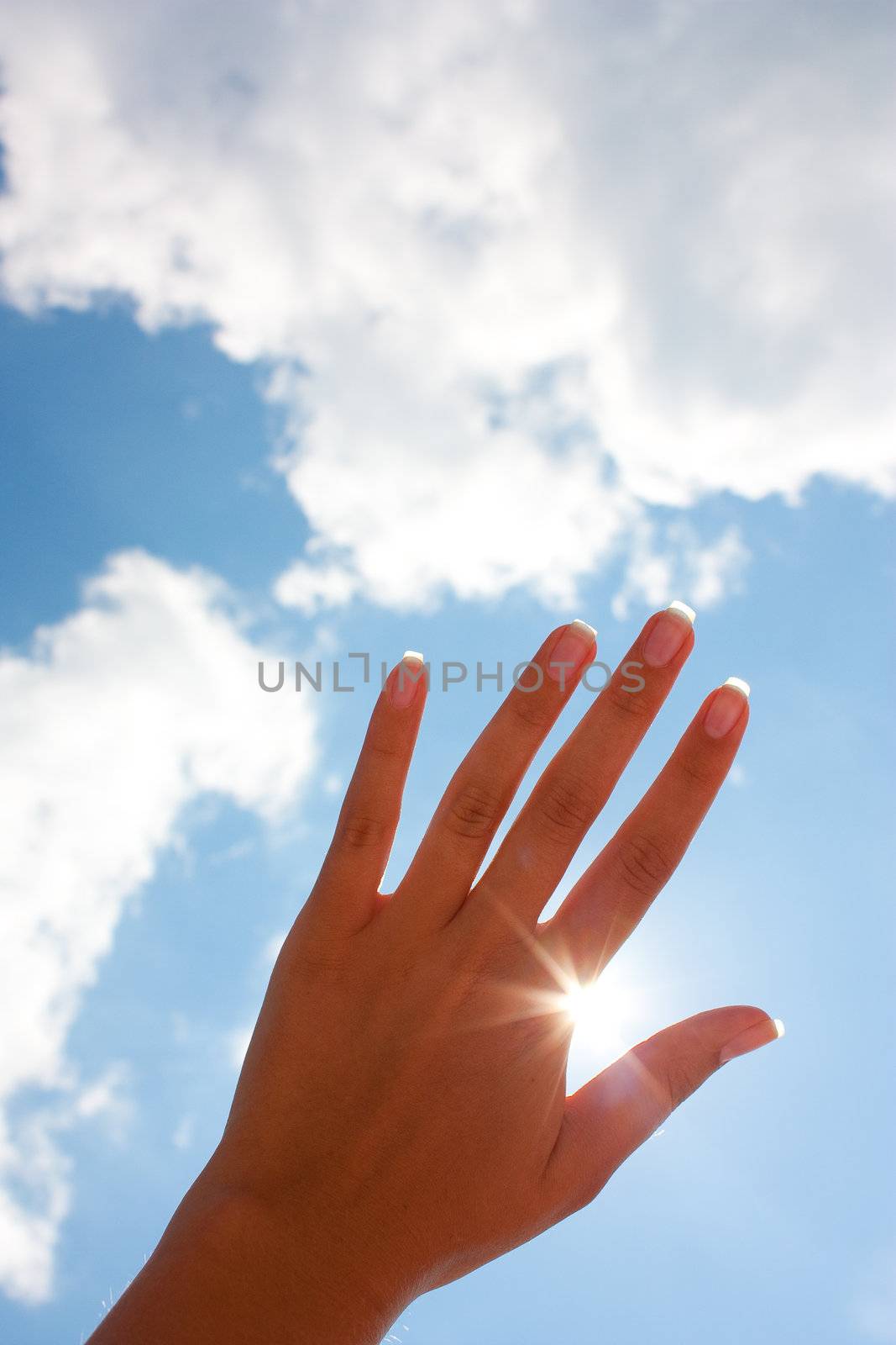 woman's hand against the blue sky
