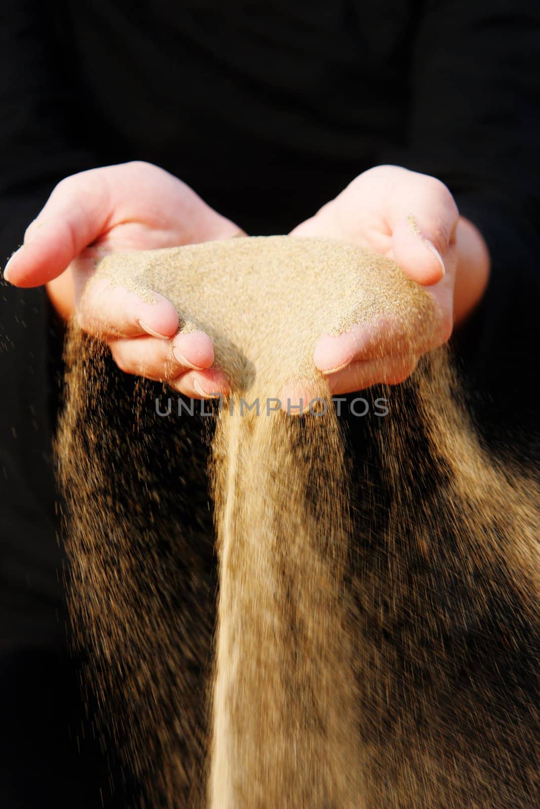 sand running through hands as a symbol for time running, lost etc.............