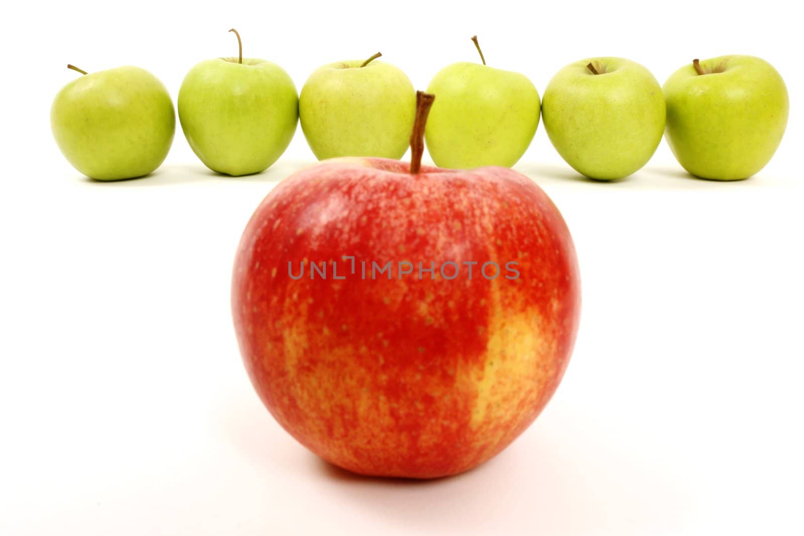 apples arranged on a white background to symbolize teamwork, leadership, discrimination............