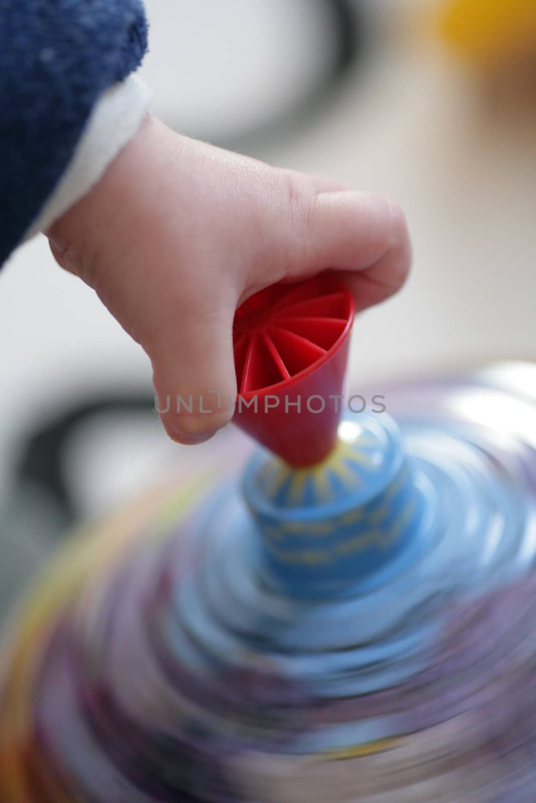 Child hand on spinner in motion