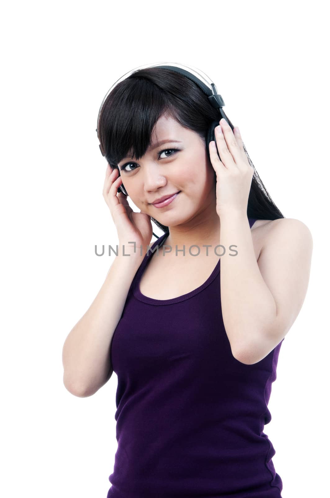 Portrait of an attractive young Asian woman listening to music over white background.