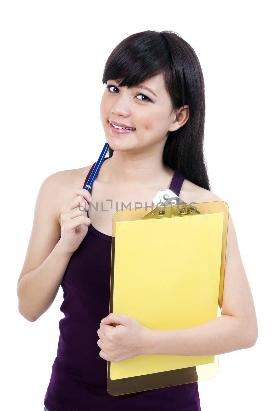 Portrait of an attractive young Asian  girl holding clipboard and pen against white background.