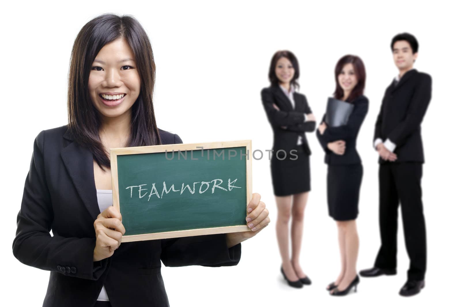 Happy smiling Asian businesswomen holding blackboard with her teammate on white background.