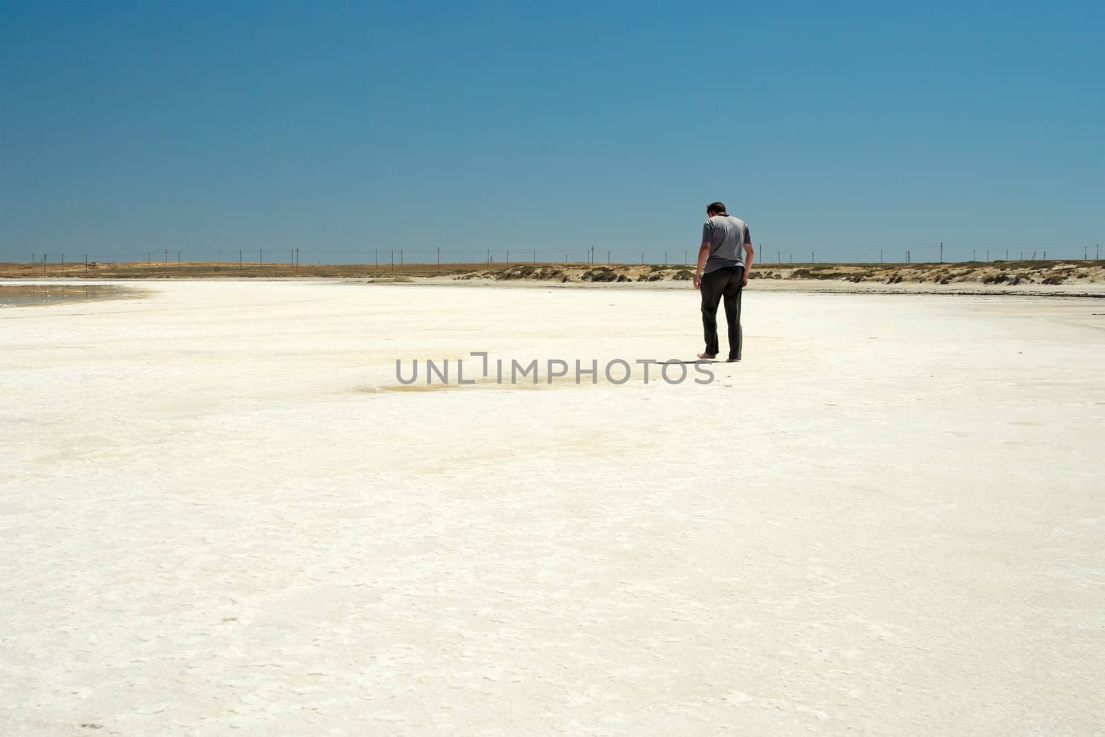 The guy walking barefoot on the salt lake.