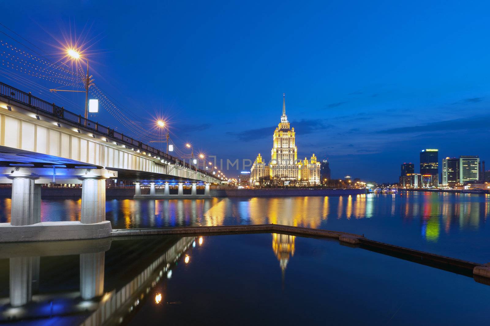  Night Moscow. Moscow River. A kind from Krasnopresnenskaya quay on hotel Ukraine and on the New Arbat bridge. 