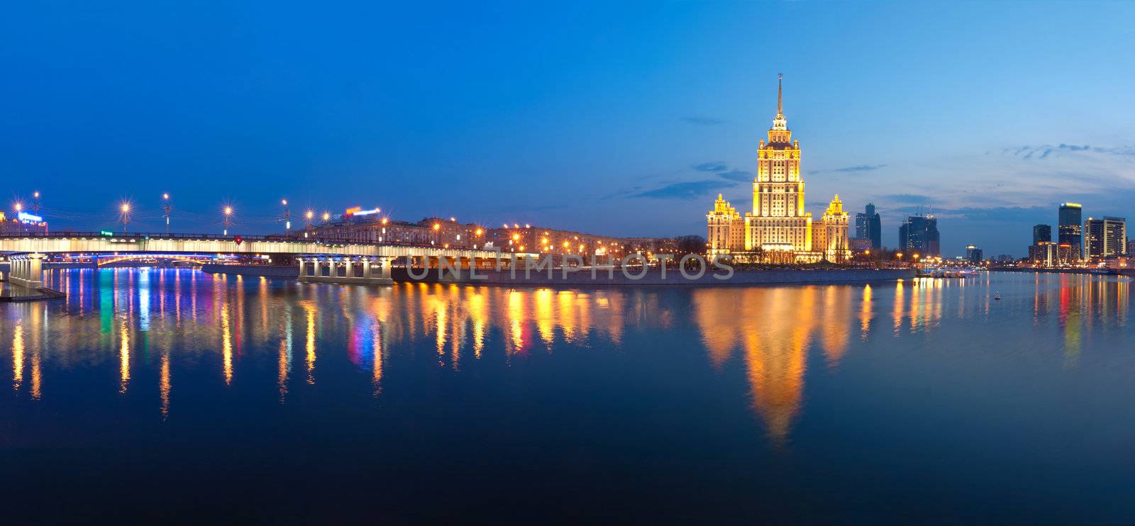  Night Moscow. Moscow River. A kind from Krasnopresnenskaya quay on hotel Ukraine and on the New Arbat bridge. Panorama.