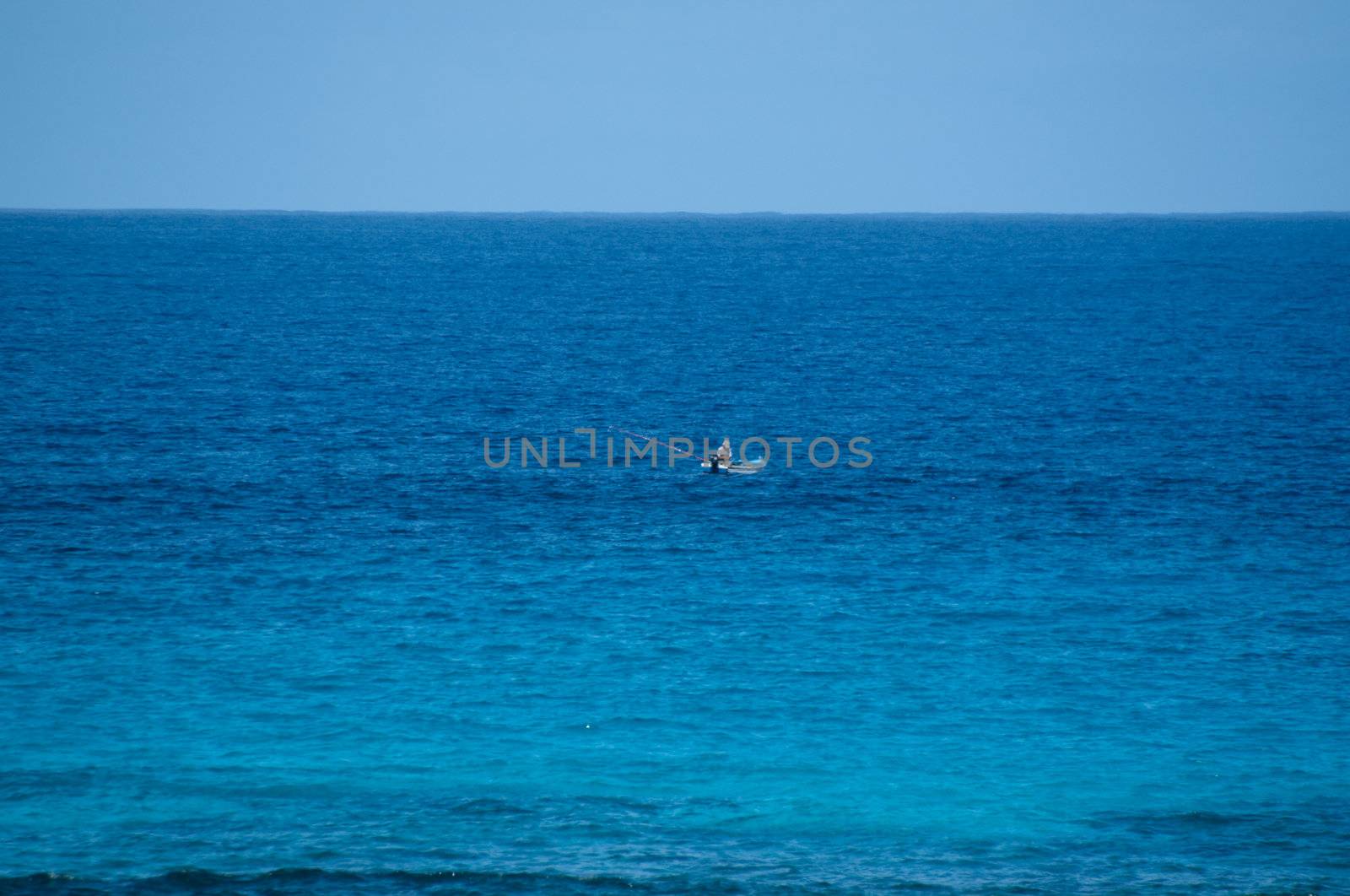 Lonely fisherman in old wooden fishing boot on Lanzarote, Canary Islands, Spain