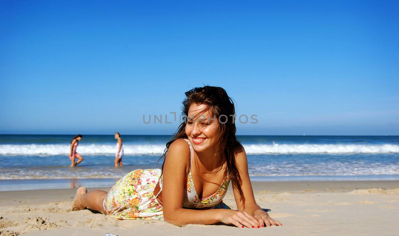 Beautiful girl lying on the beach