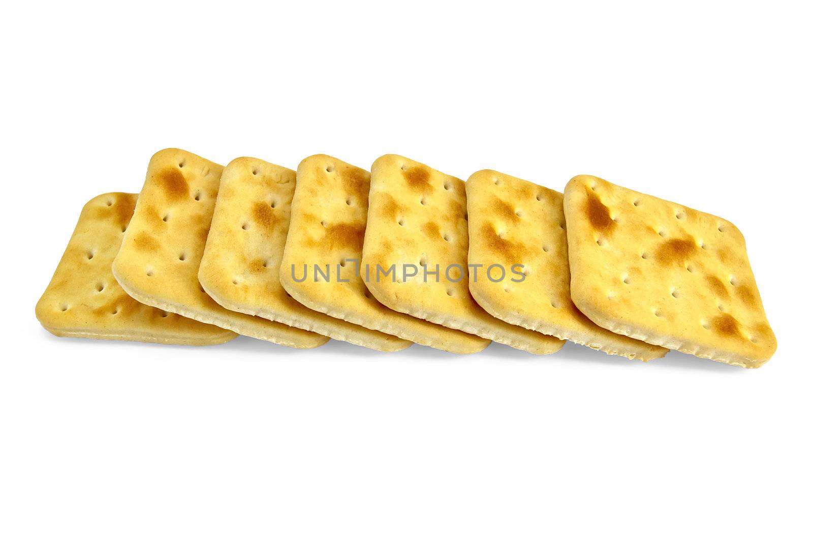 A number of golden biscuits isolated on a white background