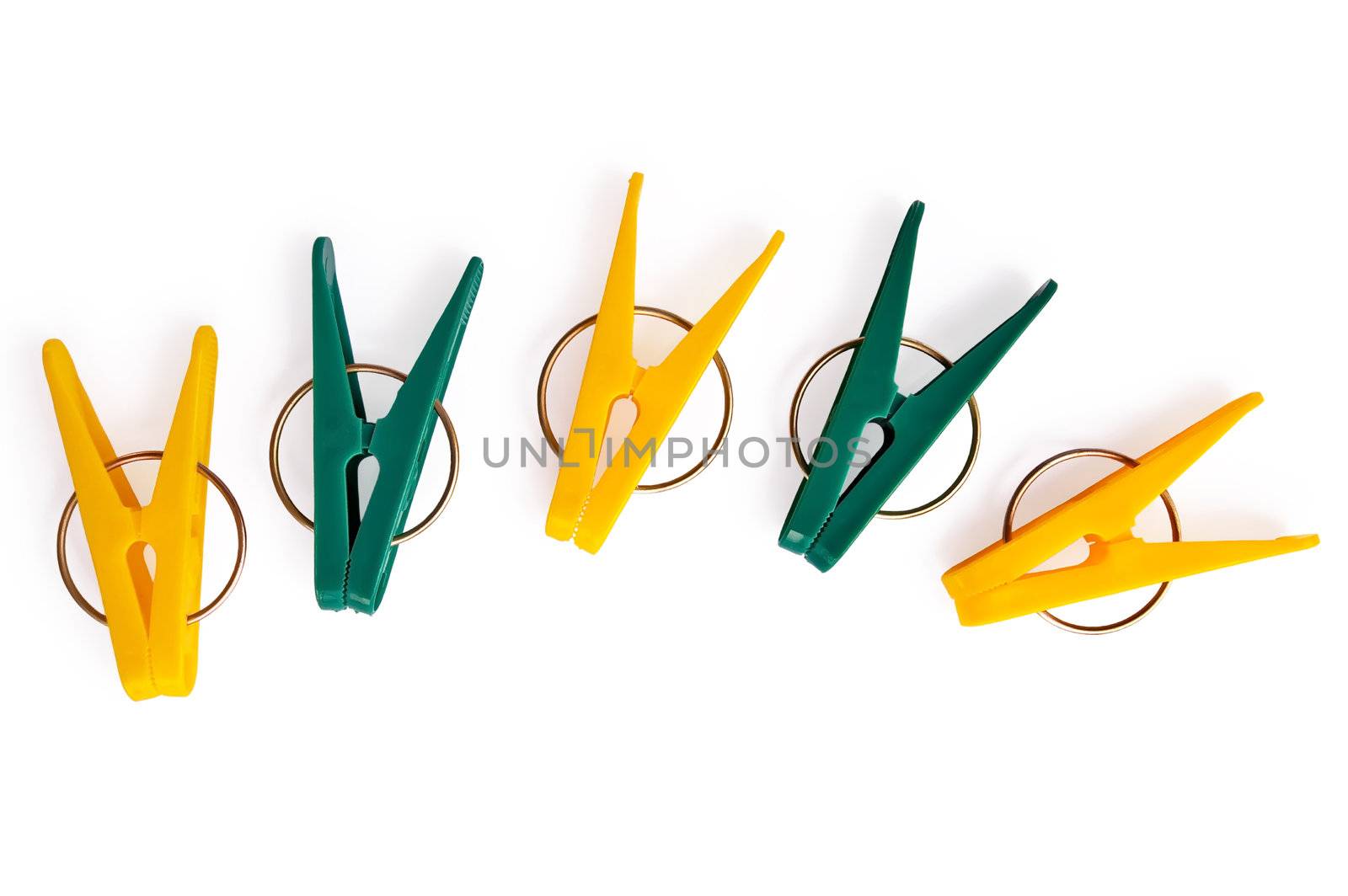 A number of yellow and green clothespins isolated on a white background