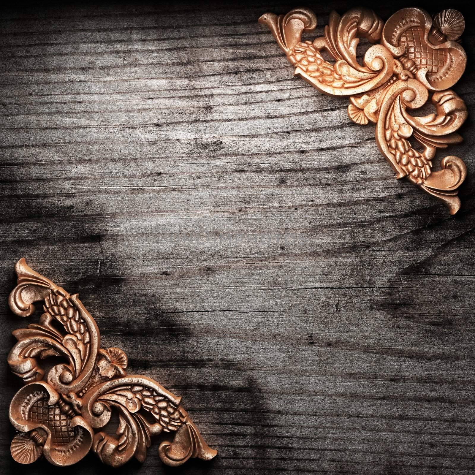 golden ornament on wood by icetray
