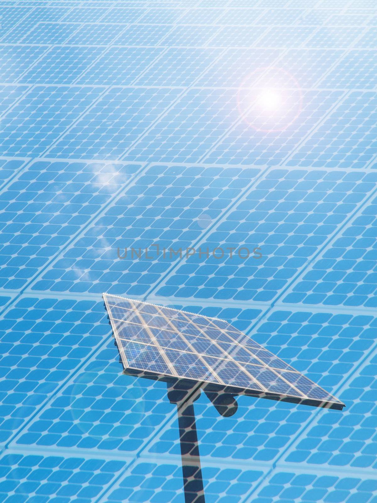 Solar panel under blue sky with sun flare